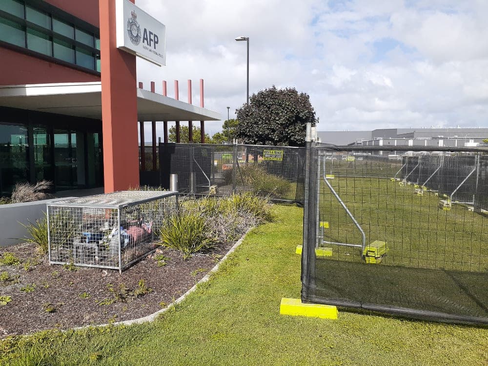Rent A Fence mesh fencing with shade cloth outside a corporate building